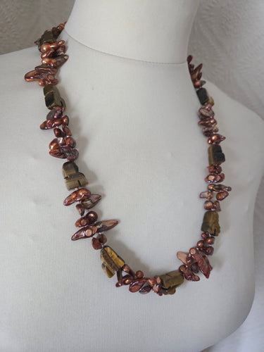 Bronze blister freshwater pearls and carved tigers eye. 24