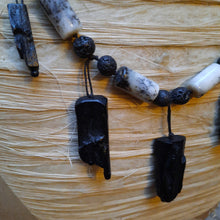 Rutile quartz, black rock and resin necklace.